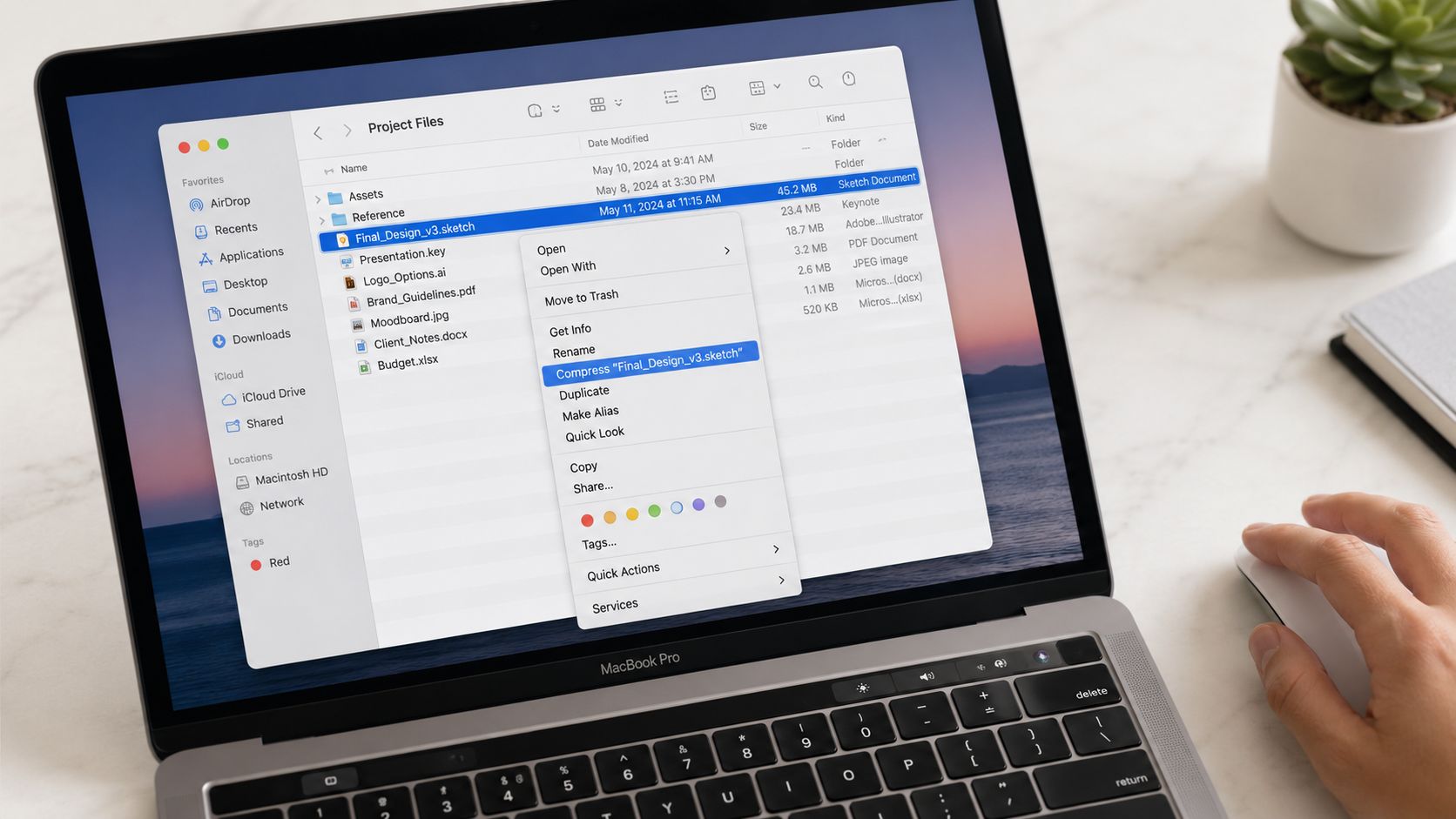 A MacBook Pro screen displaying a file system folder with the context menu open to compress a file.